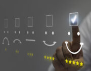 Businessman pressing smiley face emoticon on virtual touch scree